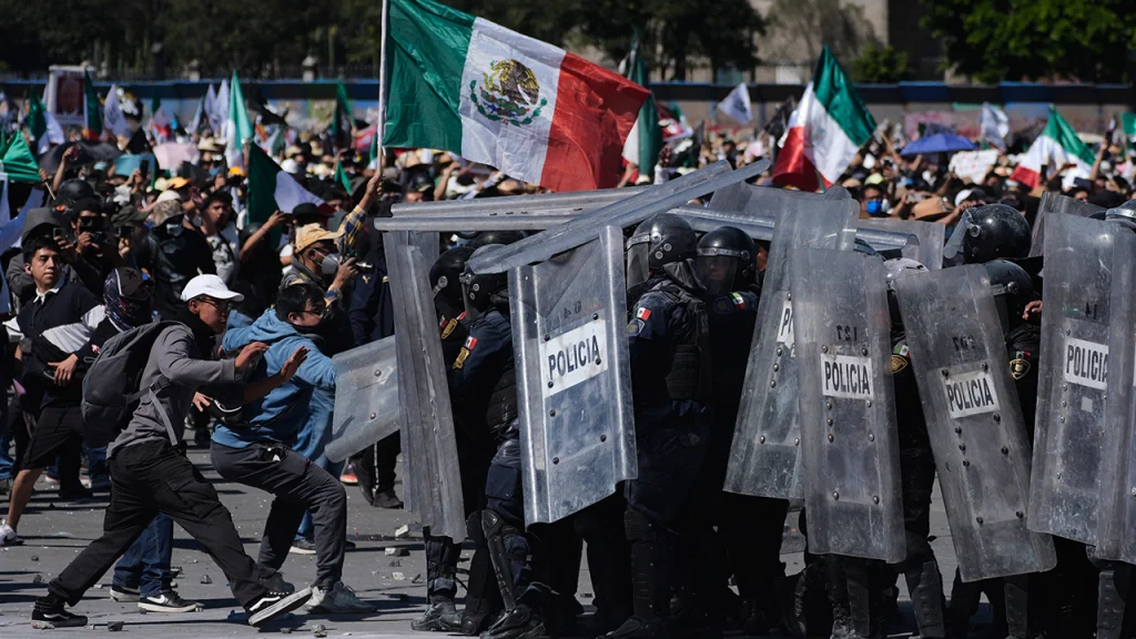 More than 100 officers injured as protesters attack police, breach barrier at Mexico’s National Palace