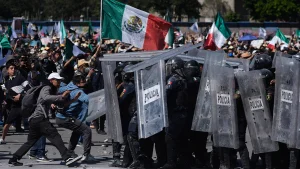 More than 100 officers injured as protesters attack police, breach barrier at Mexico’s National Palace