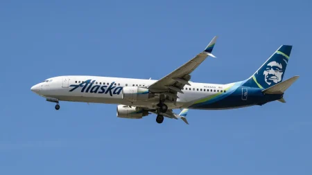 Out-of-control Alaska Airlines passenger tries to opens plane door mid-flight