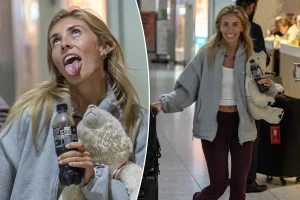 An unfazed Bonnie Blue poses for cameras upon arriving back in the UK after controversial Bali stunt