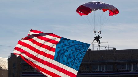 Parachutist briefly hangs above end zone during Armed Forces Bowl pregame mishap