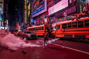 Times Square: School bus set alight amid violent scenes