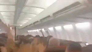 Plane passengers scream in harrowing mid-flight video as violent shaking sends cabin ceiling panels flying